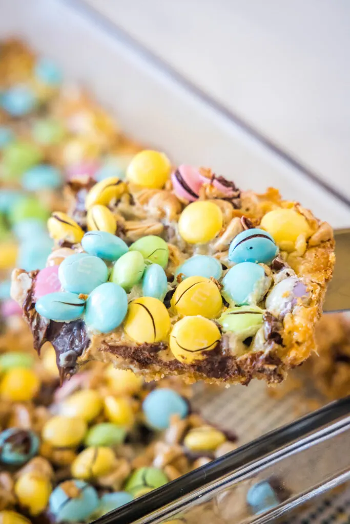 scooping a easter magic bar out of the pan