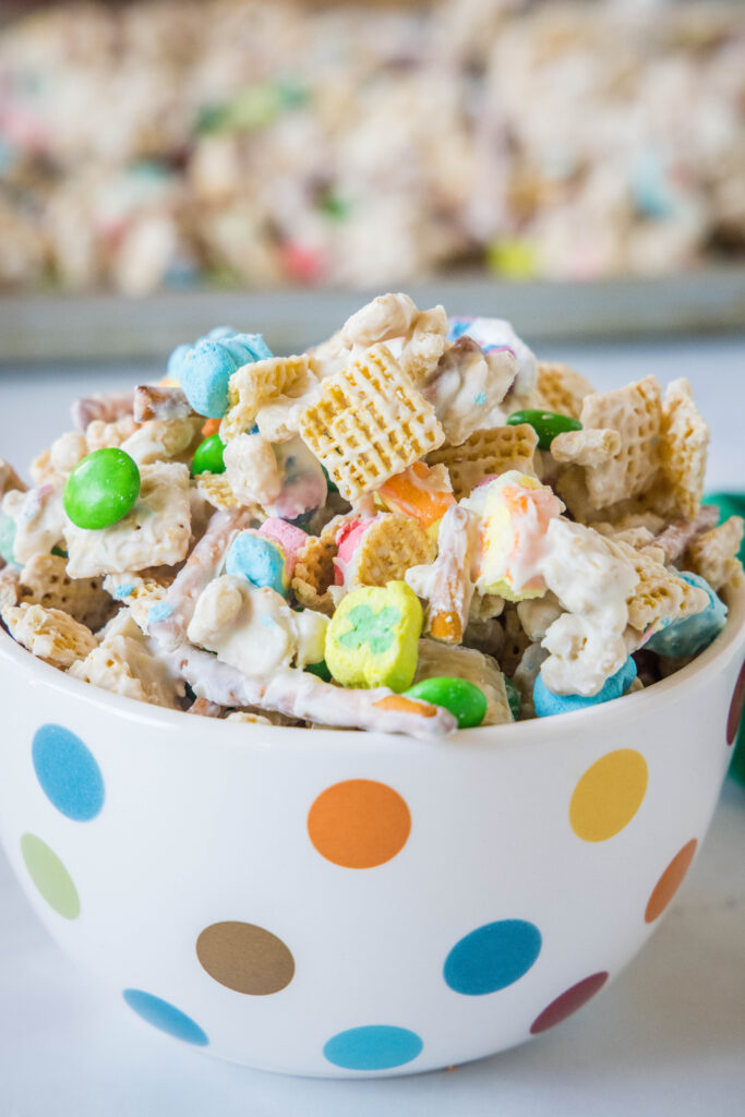 a bowl with white chocolate coated chex mix