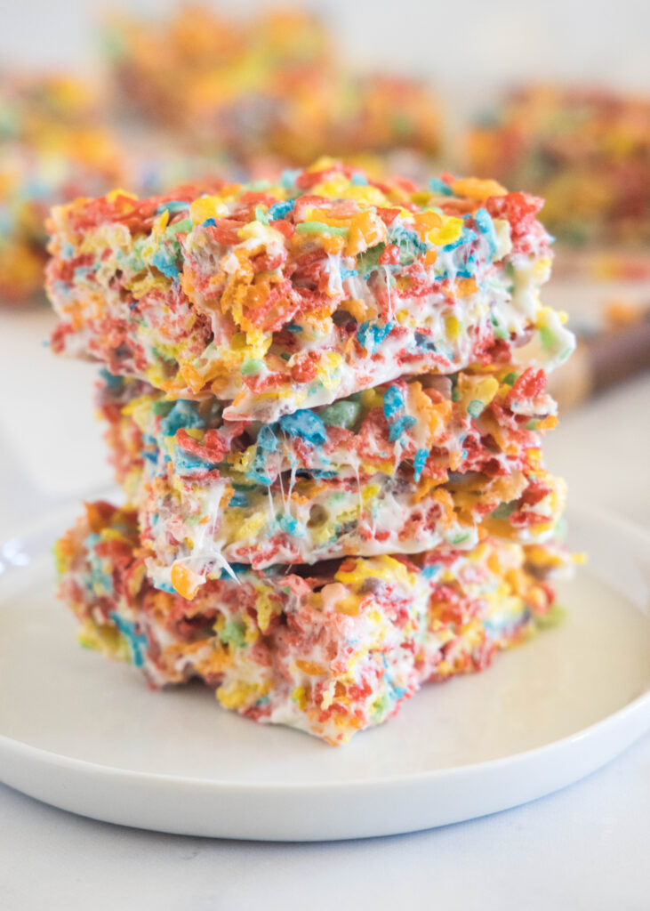 stacked fruity pebbles bars on a white plate