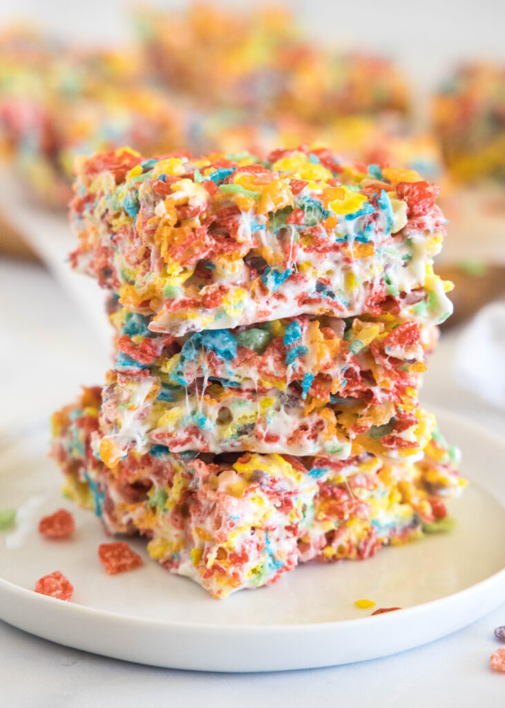 stacked fruity pebbles bars on a white plate