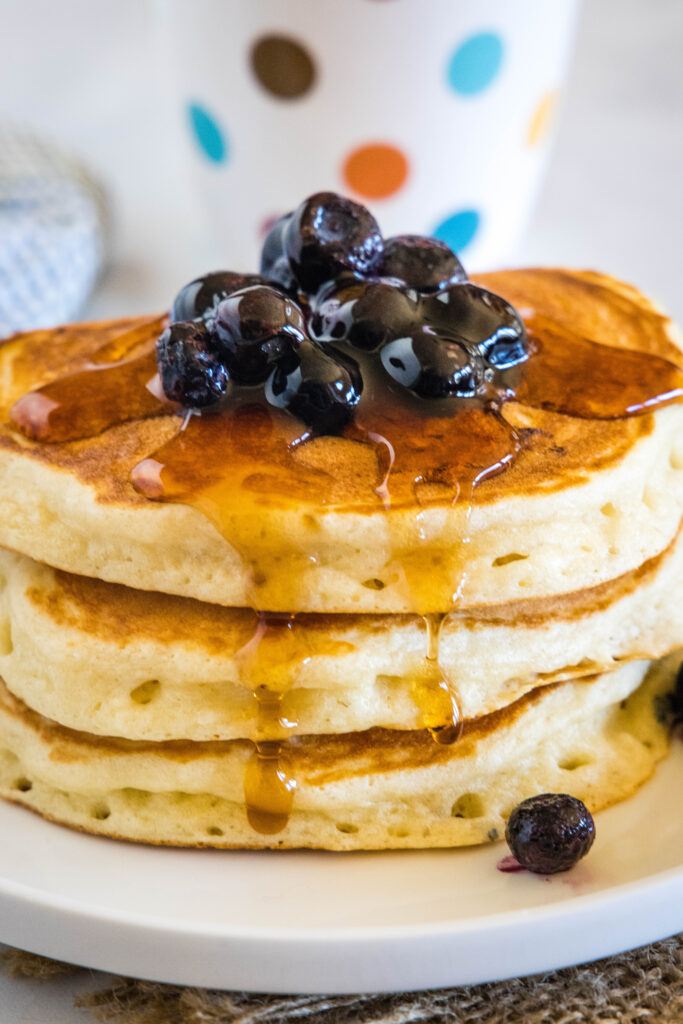 pancakes topped with blueberries and syrup