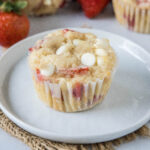 cropped close up strawberry white chocolate chip muffin on a plate