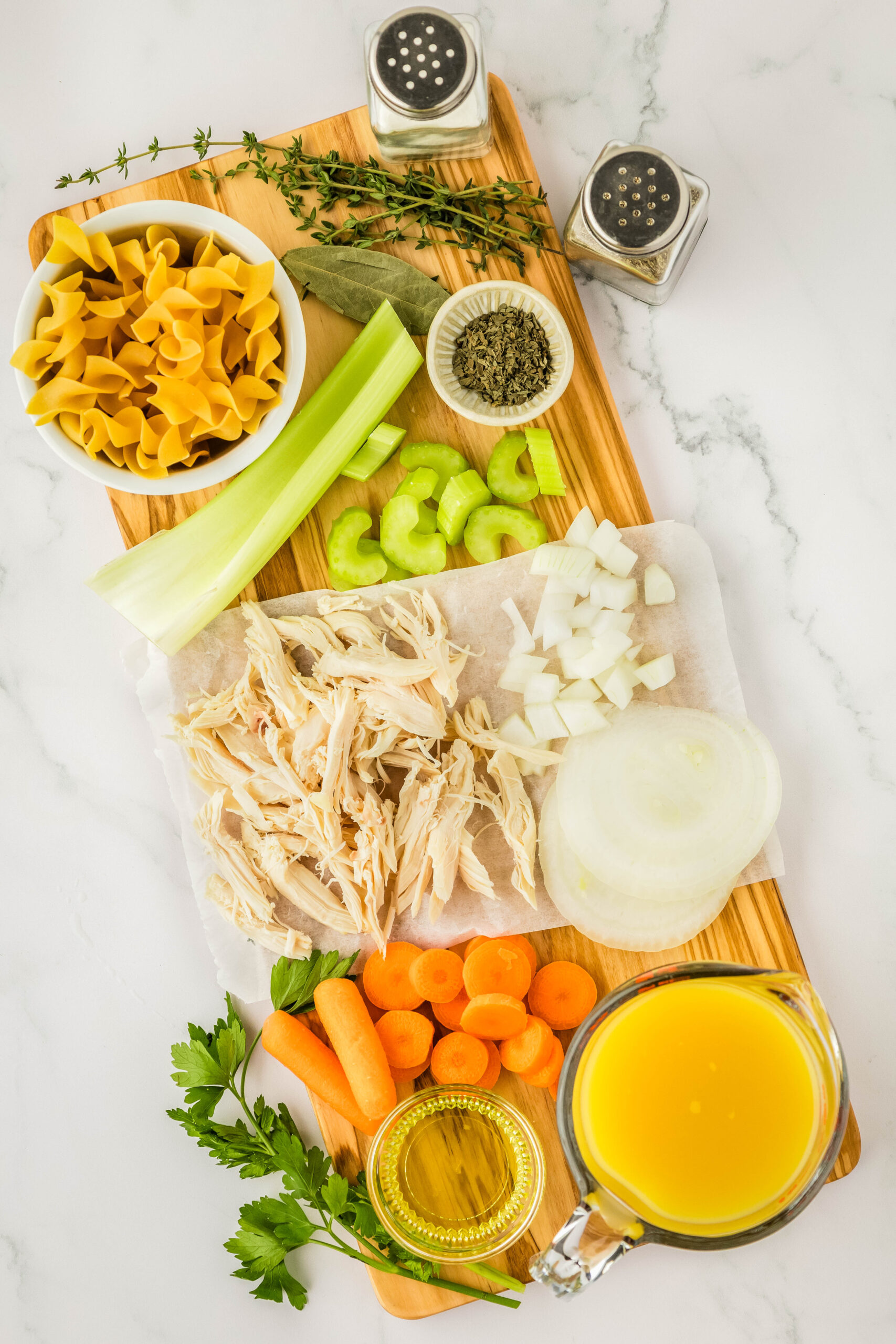 chicken noodle soup ingredients on a board