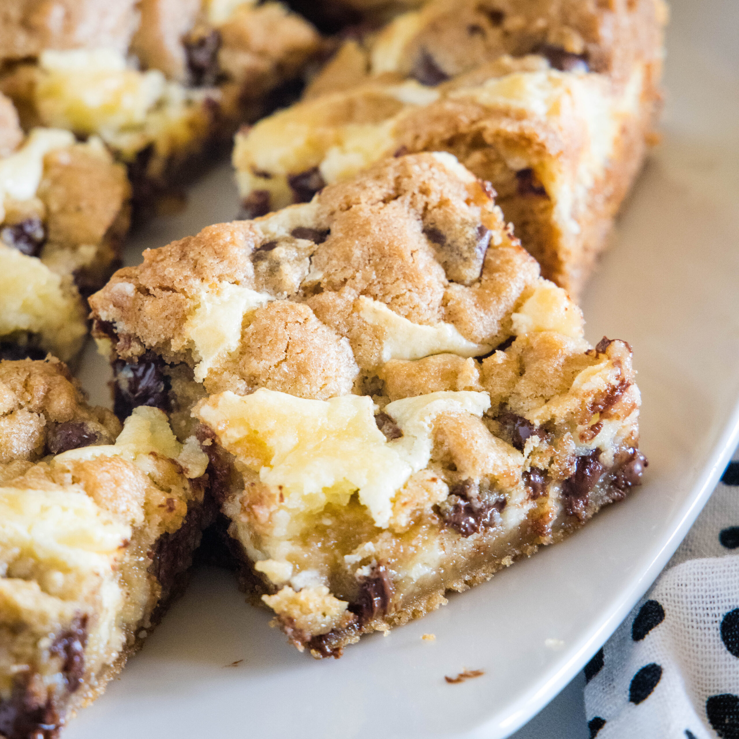 cropped close up chocolate chip cookie cheesecake bars