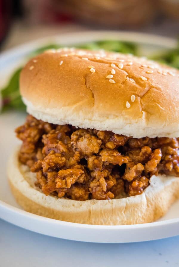 Close up of a ground turkey sloppy joes sandwich on a plate.