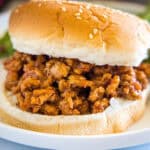 Close up of a ground turkey sloppy joes sandwich on a plate.