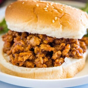 Close up of a ground turkey sloppy joes sandwich on a plate.