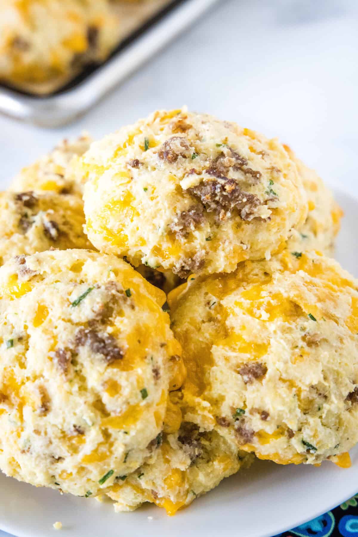 cheese and sausage biscuits on a white plate