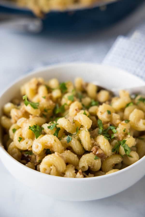 Toasted walnut pasta in a white bowl.