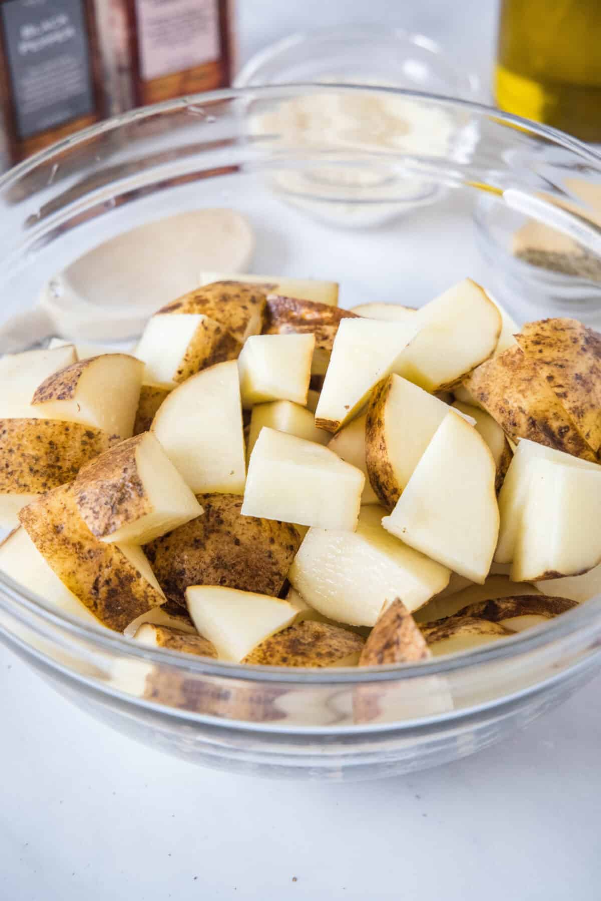Cubed potatoes in a glass bowl.