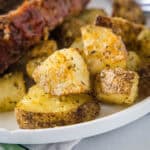 Close up of seasoned oven roasted potatoes on a plate.