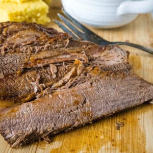 cropped close up sliced brisket on cutting board