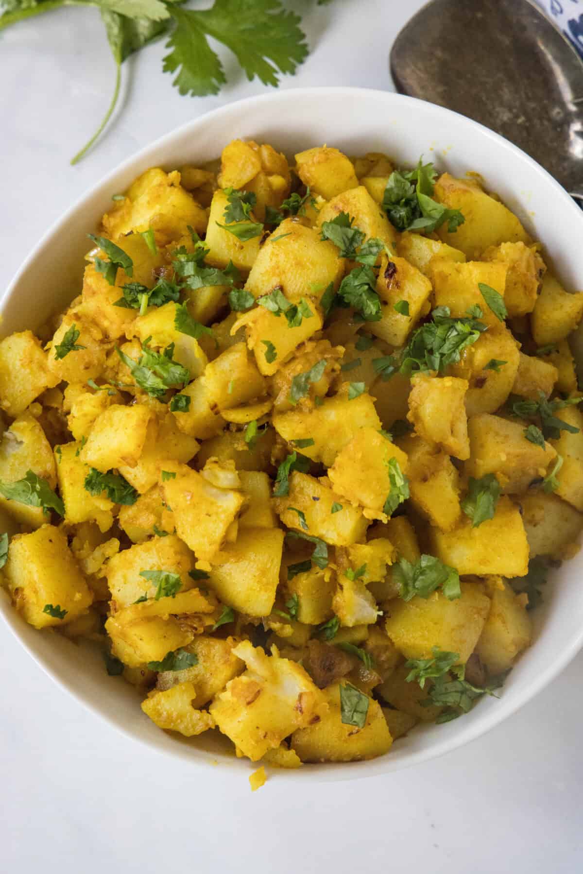 Curried Potatoes with Chickpeas looking down on bowl of curried potatoes