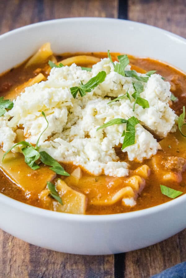 close up slow cooker lasagna soup in a white bowl