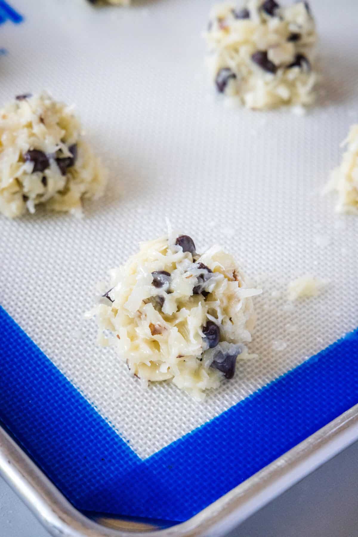 coconut cookie balls on baking tray ready for the oven