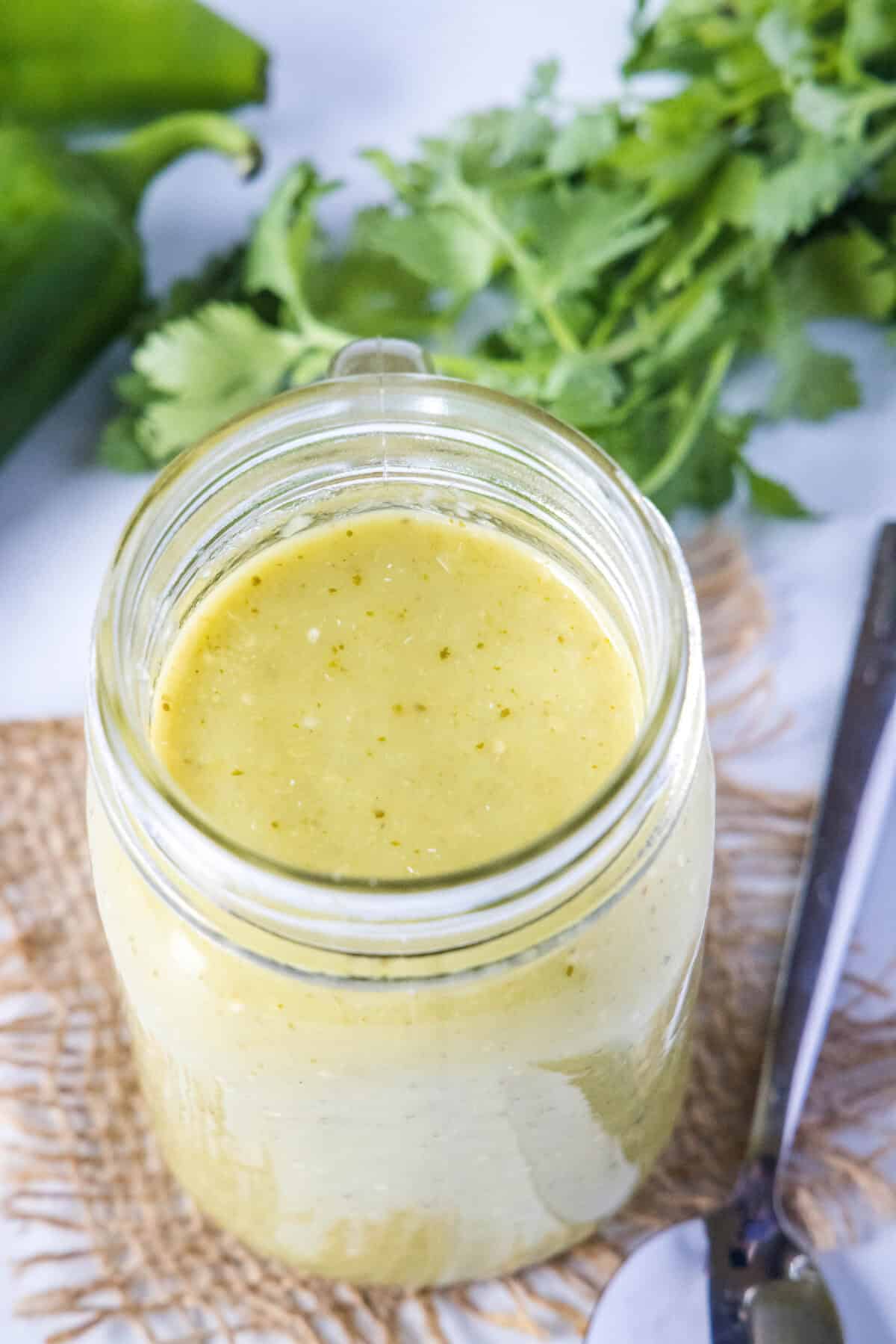 looking down on a jar of homemade green enchilada sauce