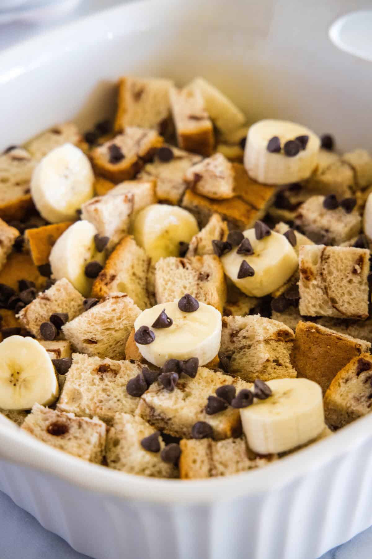 layer of sliced bread, mini chocolate chips and slices banana