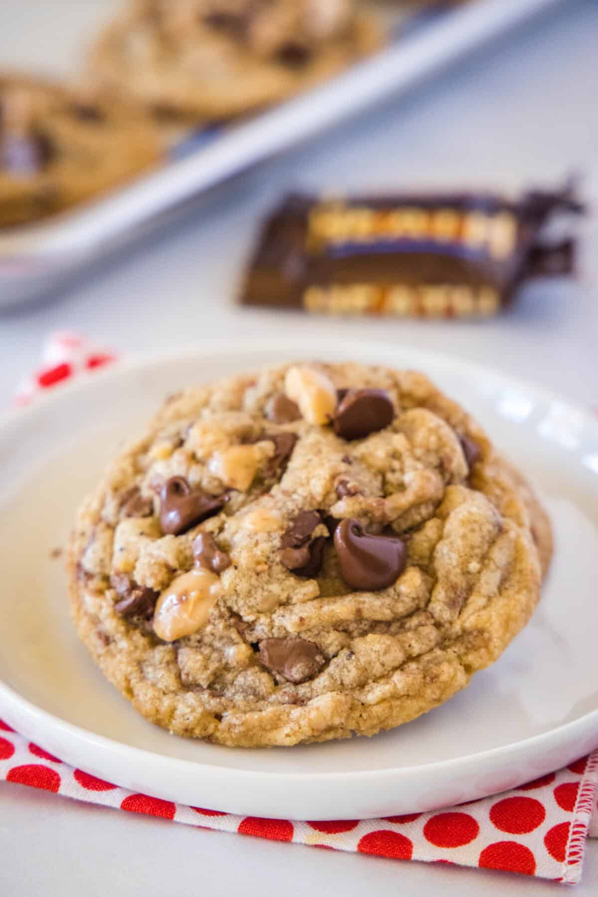 white plate with chocolate chip toffee cookies on it