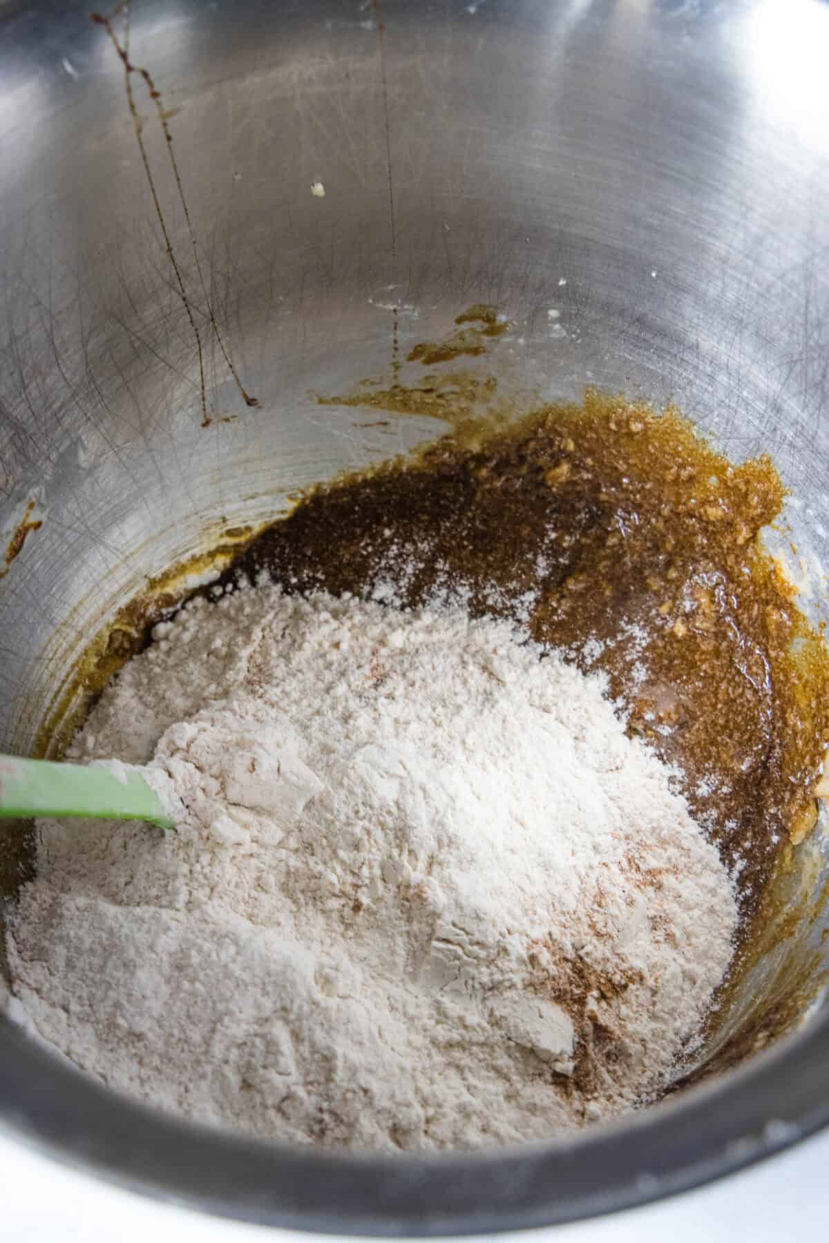 mixing dry ingredients into wet ingredients in mixing bowl