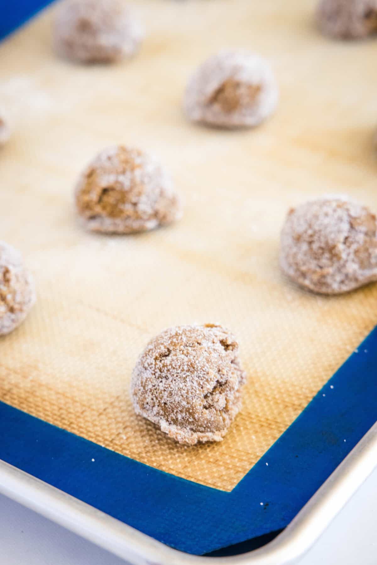 molasses cookie balls on baking tray ready for the oven