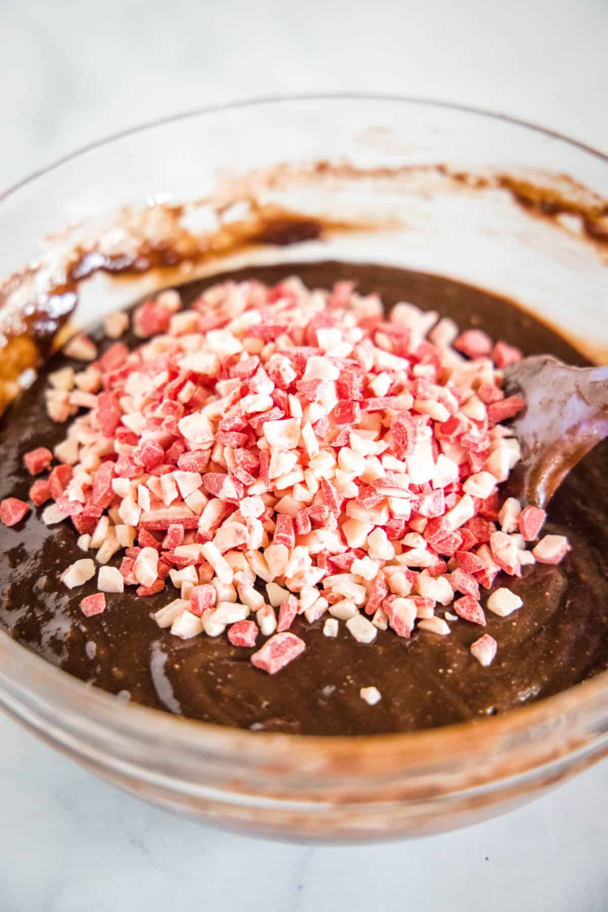 adding peppermint crunch candy to brownie batter