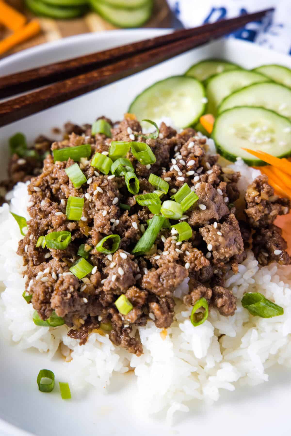 korean beef over rice with cucucumbers and carrots