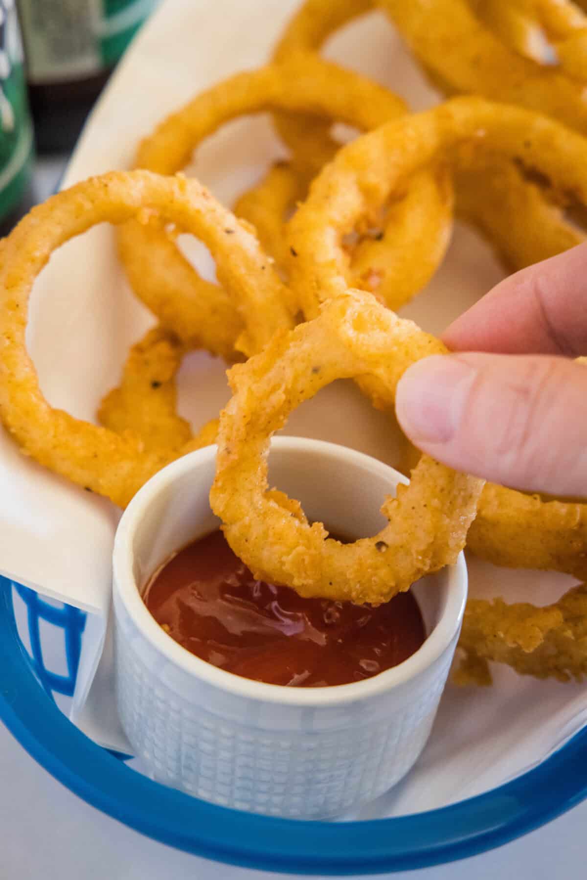 onion ring being dipped in ketchup