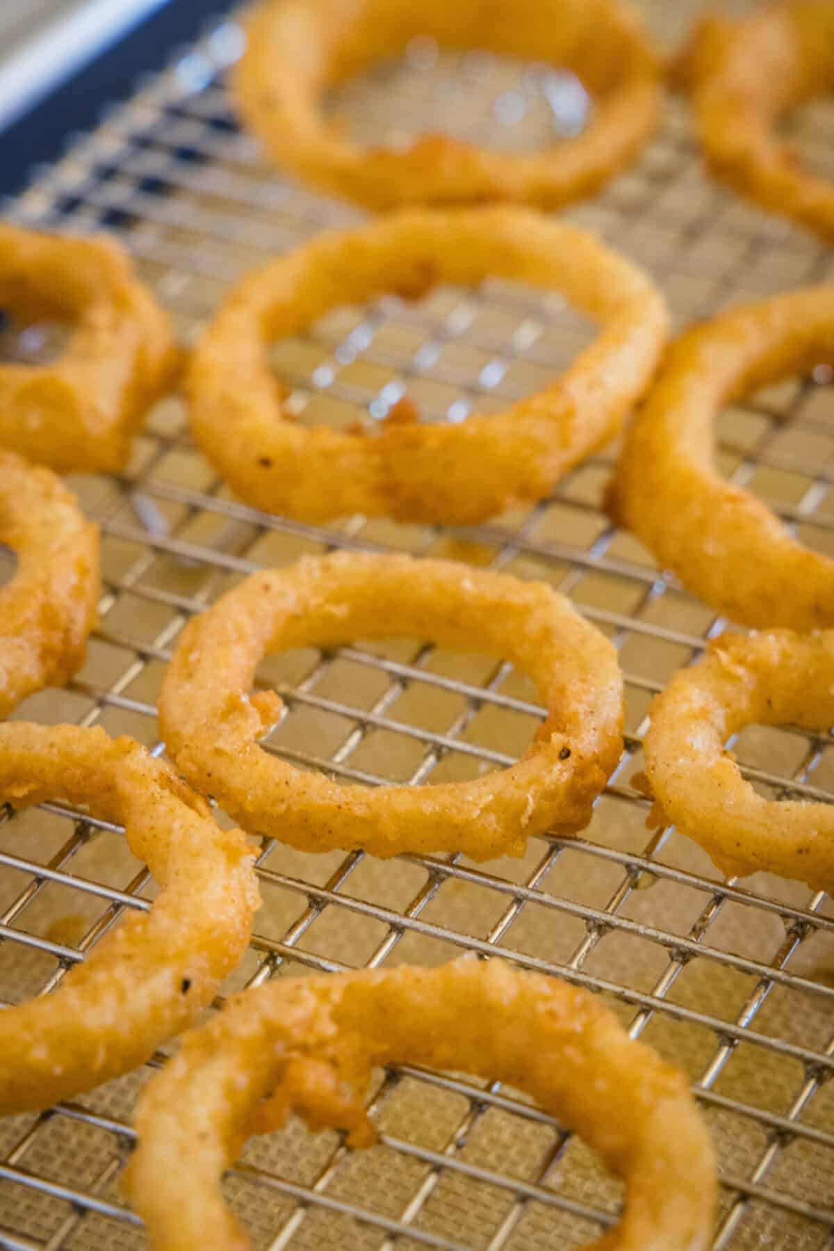 onion rings on a wire rack cooling