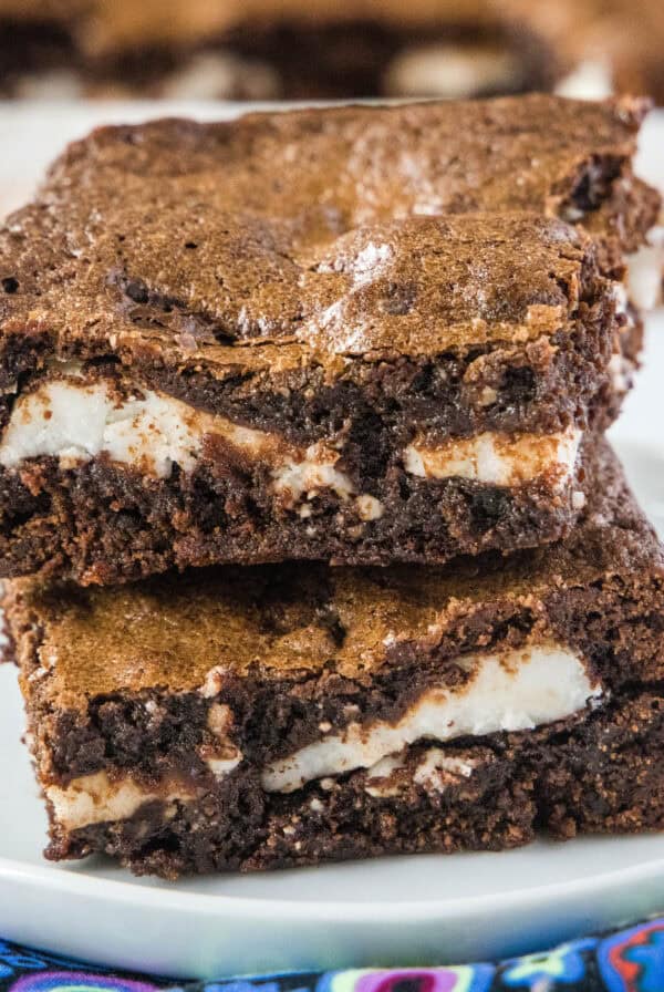 cropped close up stacked peppermint patty brownies on a white plate
