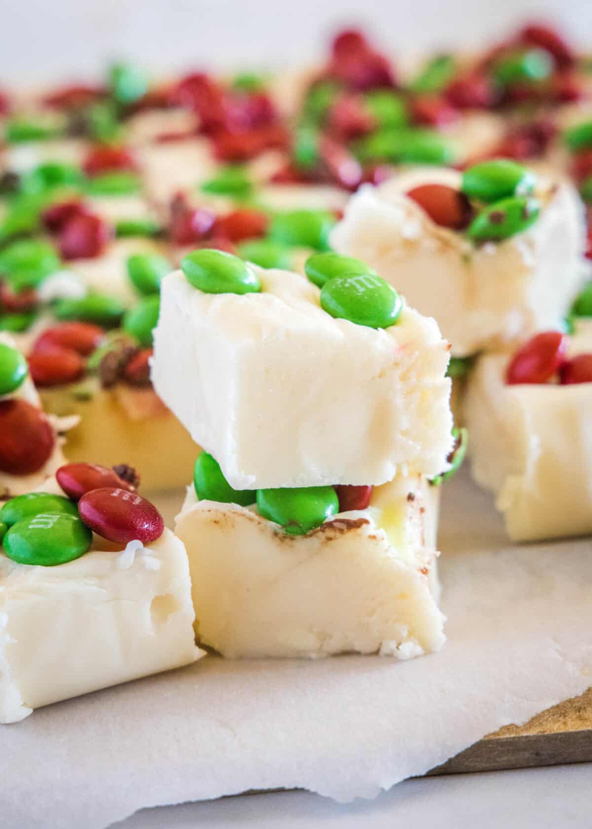white chocolate fudge stacked on a cutting board