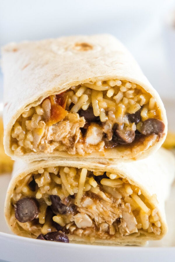 crockpot chicken burritos cut in half on a plate