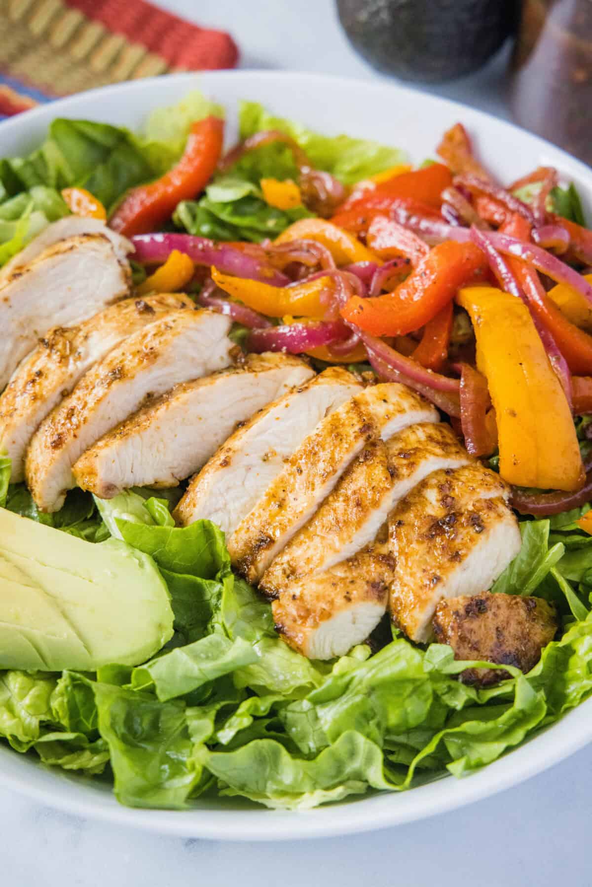 sliced chicken on chicken fajita salad