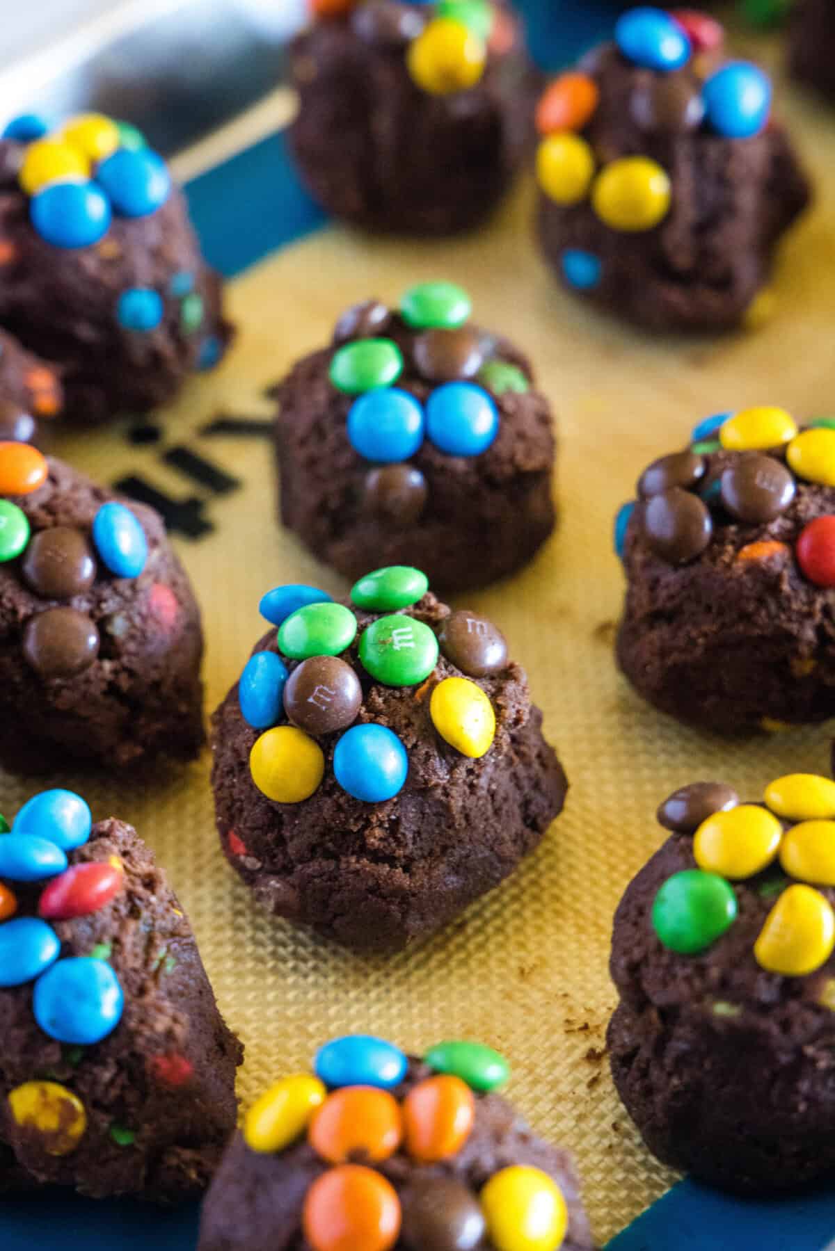 balls of cookie dough topped with mini M&M's