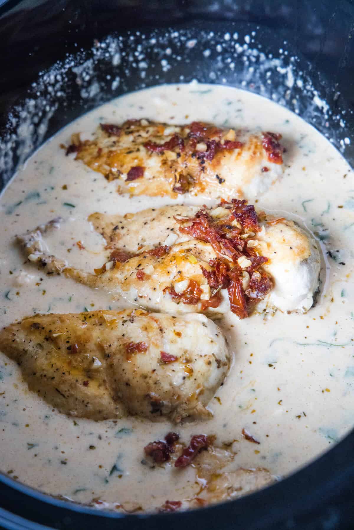adding chicken back to the slow cooker in sauce