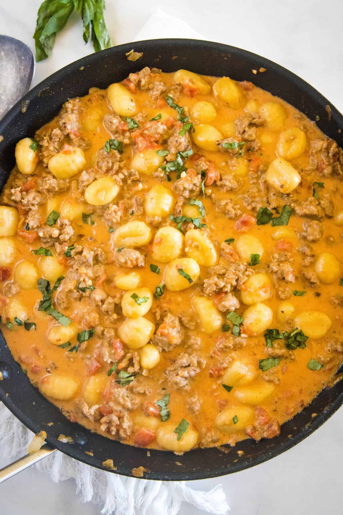 looking down on skillet with gnocchi with sausage in it