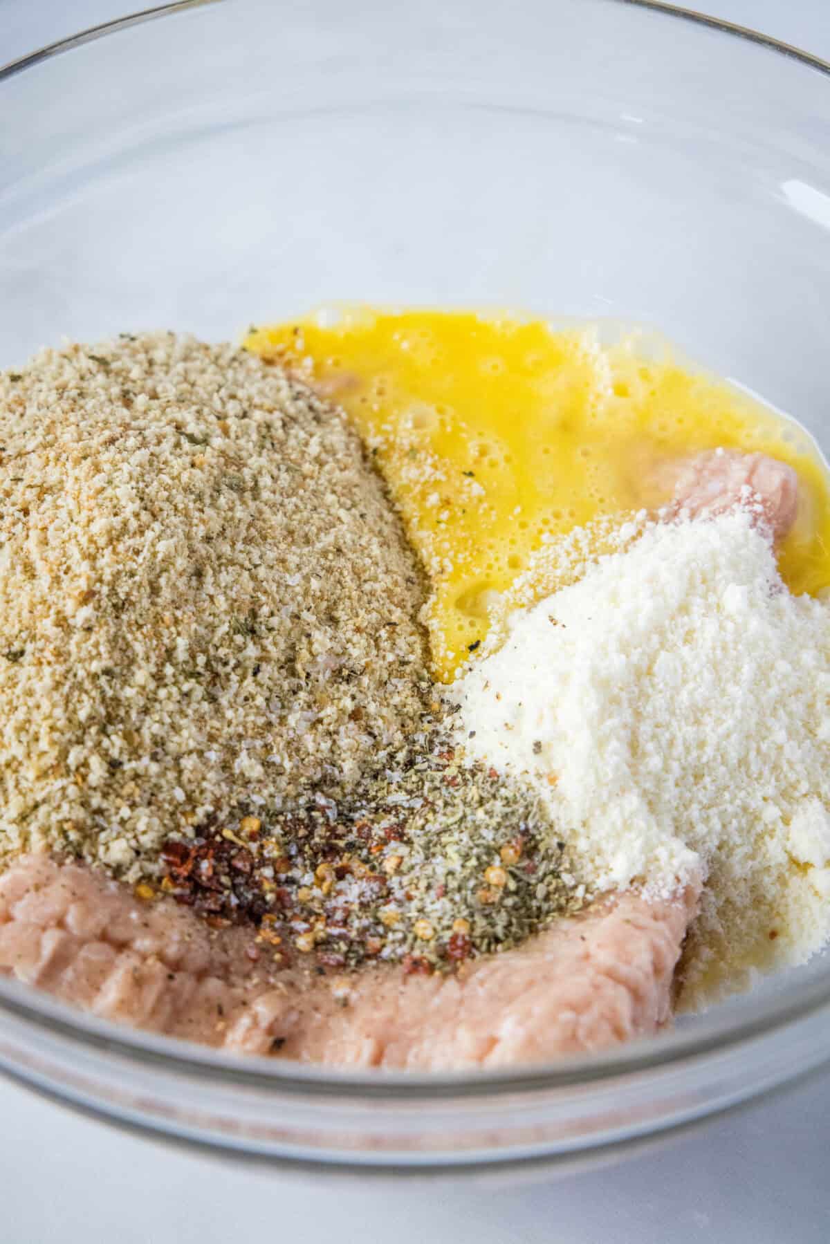 chicken meatballs ingredients in a mixing bowl