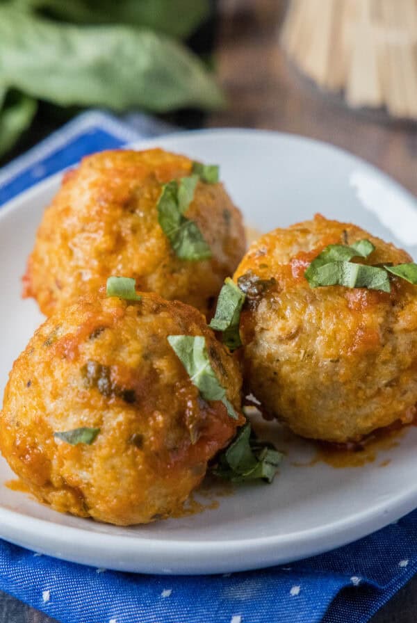 cropped close up italian chicken meatballs on a white plate