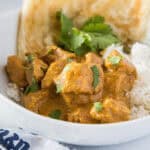 cropped close up chicken tikka masala over rice in a bowl