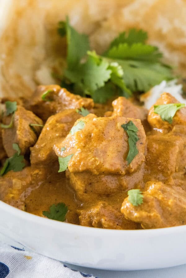 cropped close up chicken tikka masala over rice in a bowl