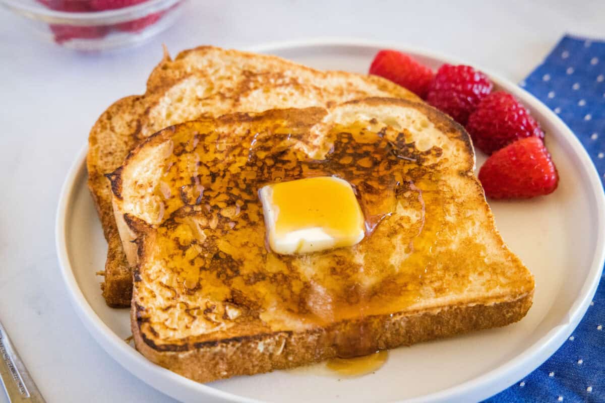 This Sourdough French Toast is the perfect use for leftover sourdough. Thick slices of sourdough soak up a rich egg mixture and cook to golden perfection.