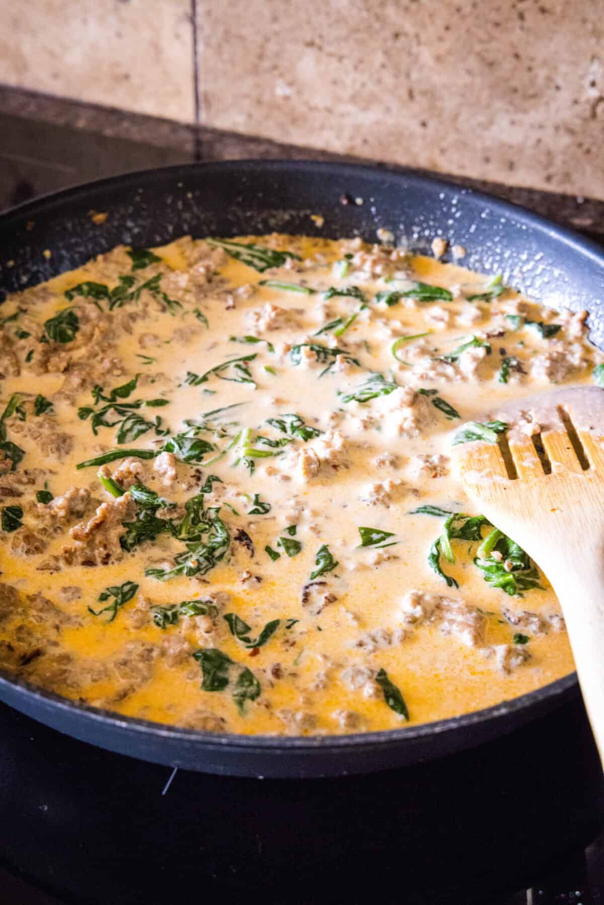 wilted spinach in sausage cream sauce
