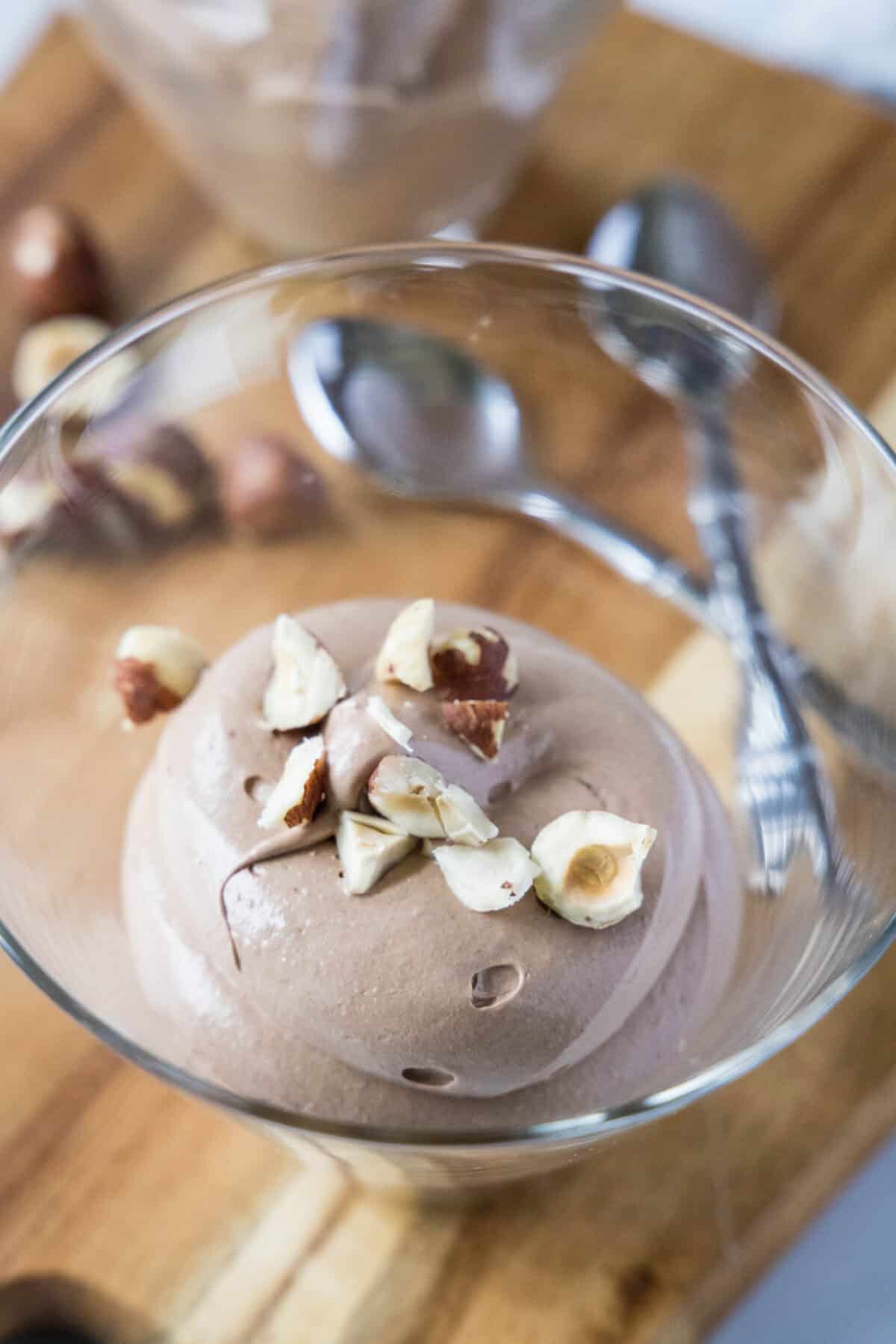 nutella mousse in a glass with hazelnuts on top