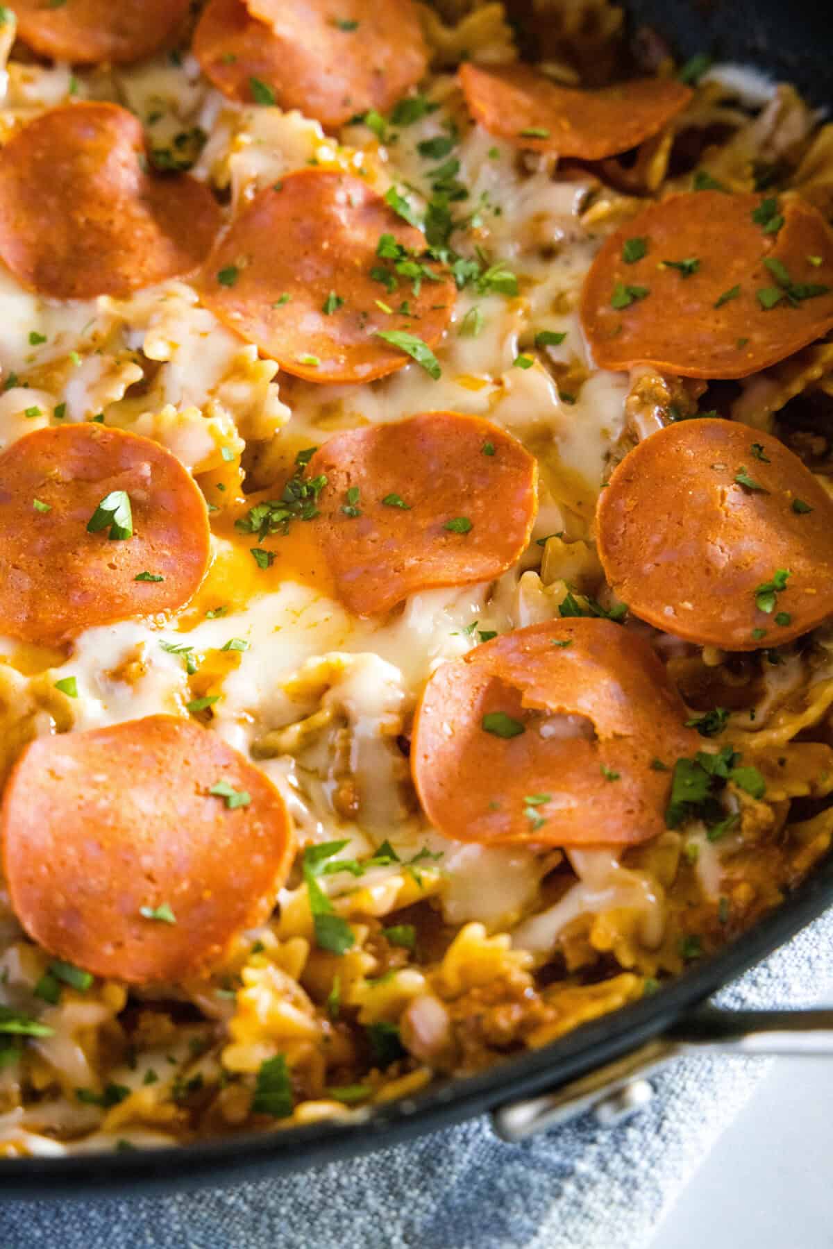 looking down on a skillet with pizza pasta