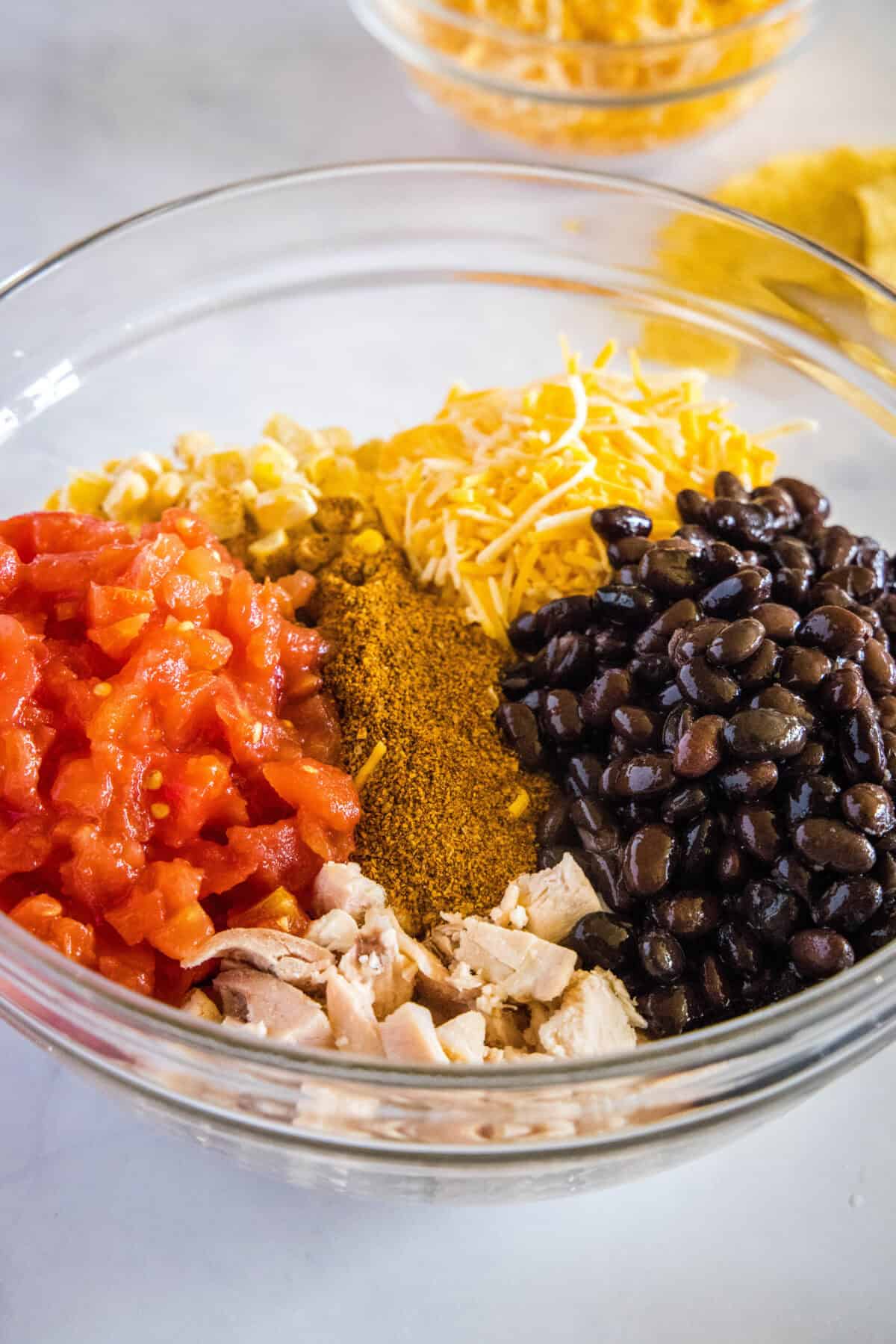chicken taco casserole ingredients in mixing bowl