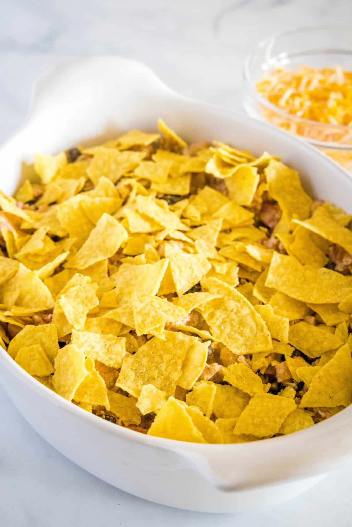 adding crushed tortilla chips to casserole