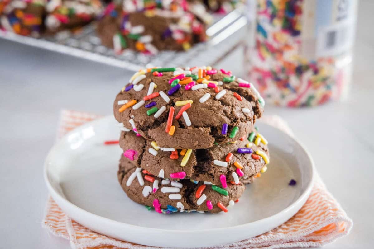 Chocolate Sprinkle Cookies - chocolate cookies from cake mix are super easy to make! Just 3 ingredients to make these thick, chewy, and fudgy cookies. Coated in fun sprinkles for any occasion.