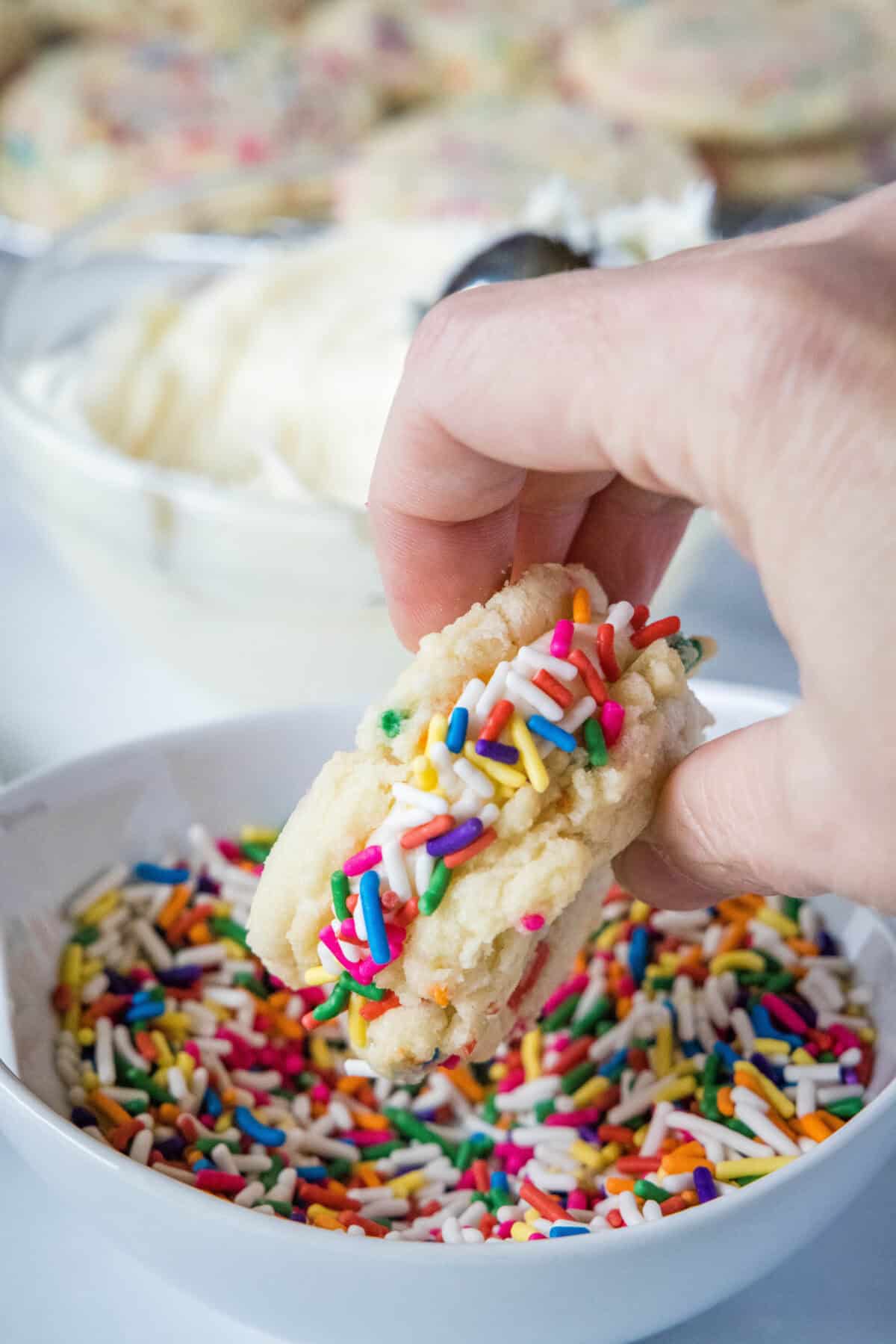 rolling sandwich cookies in sprinkles