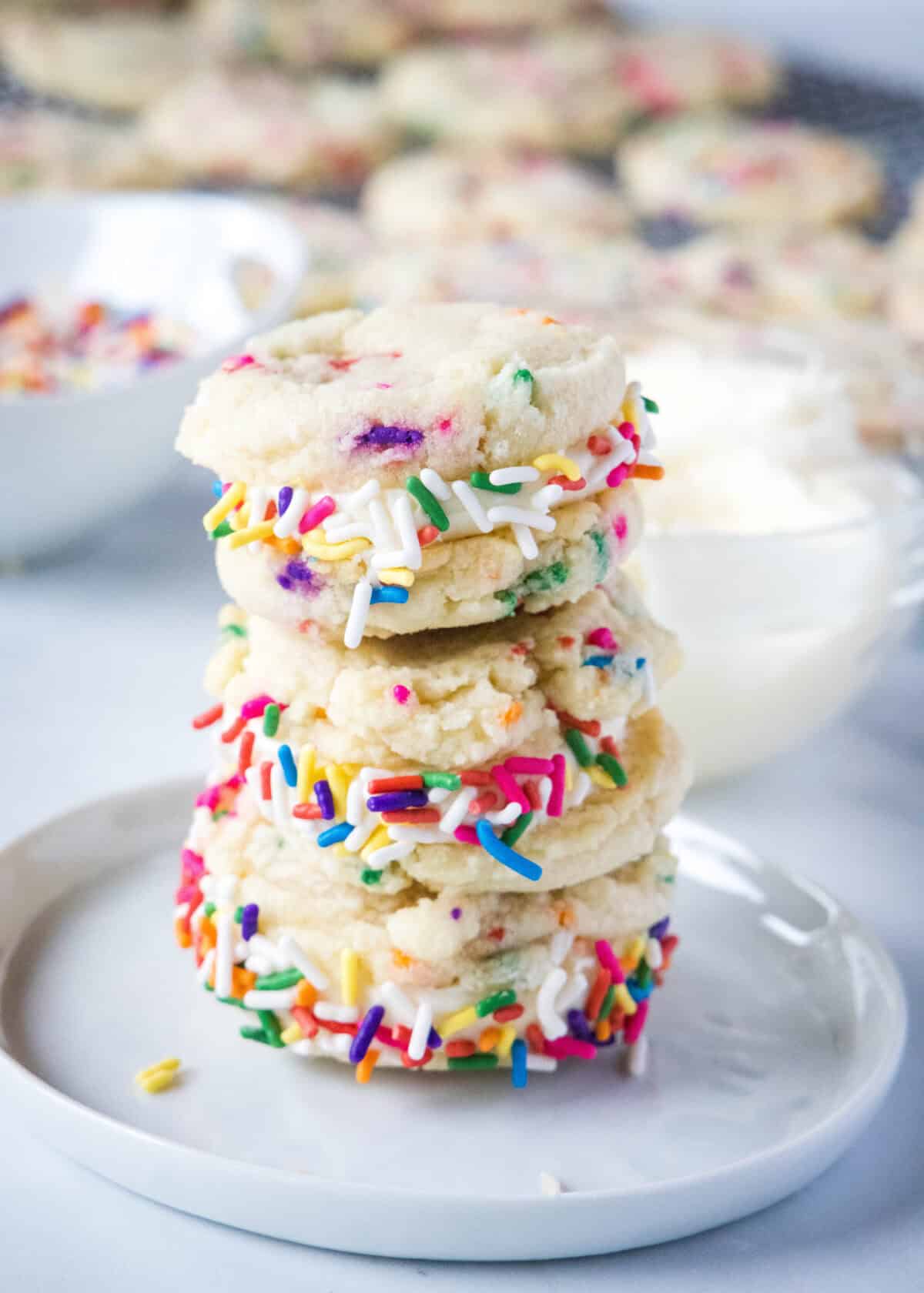 funfetti sandwich cookies stacked on a plate