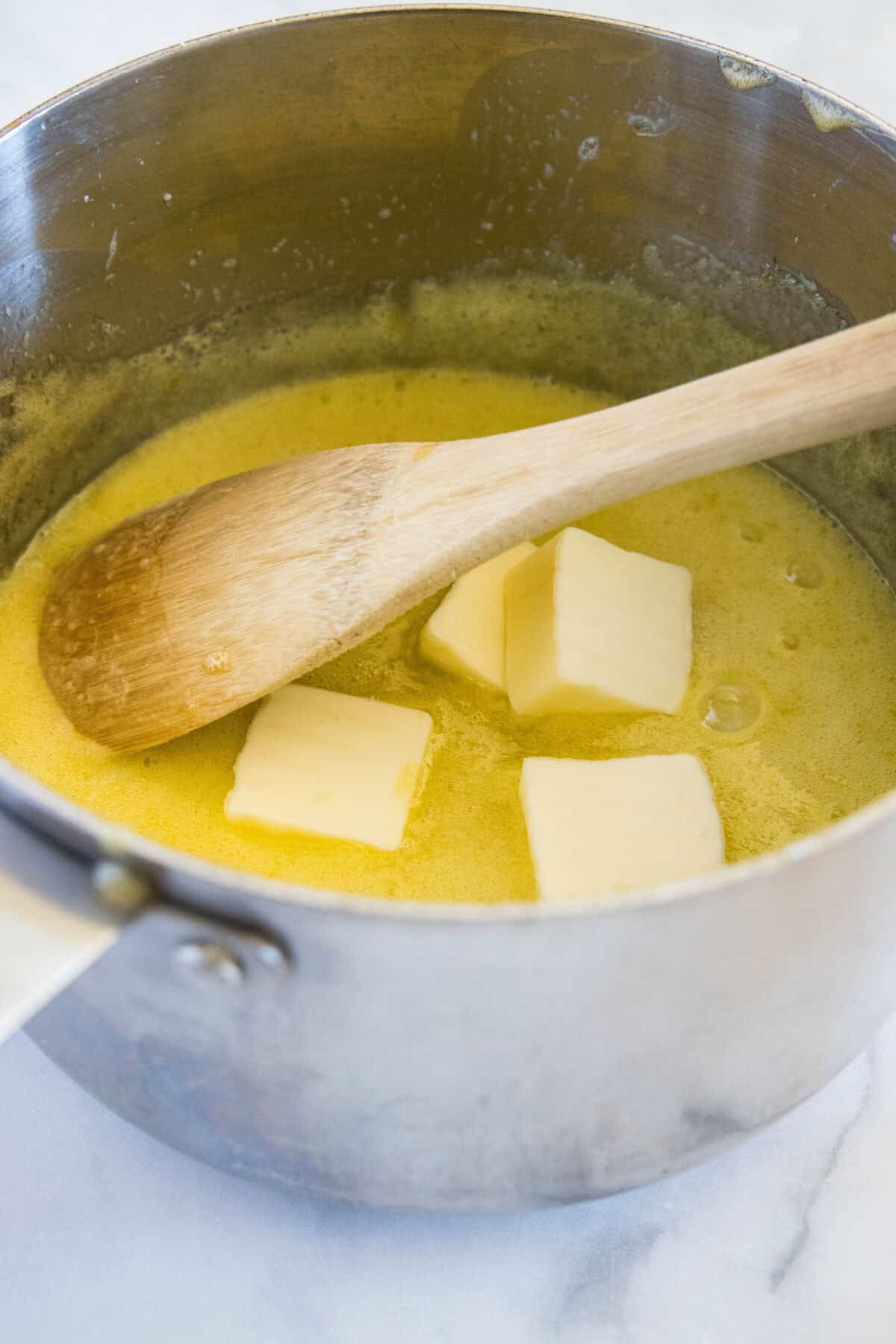 adding butter to pan