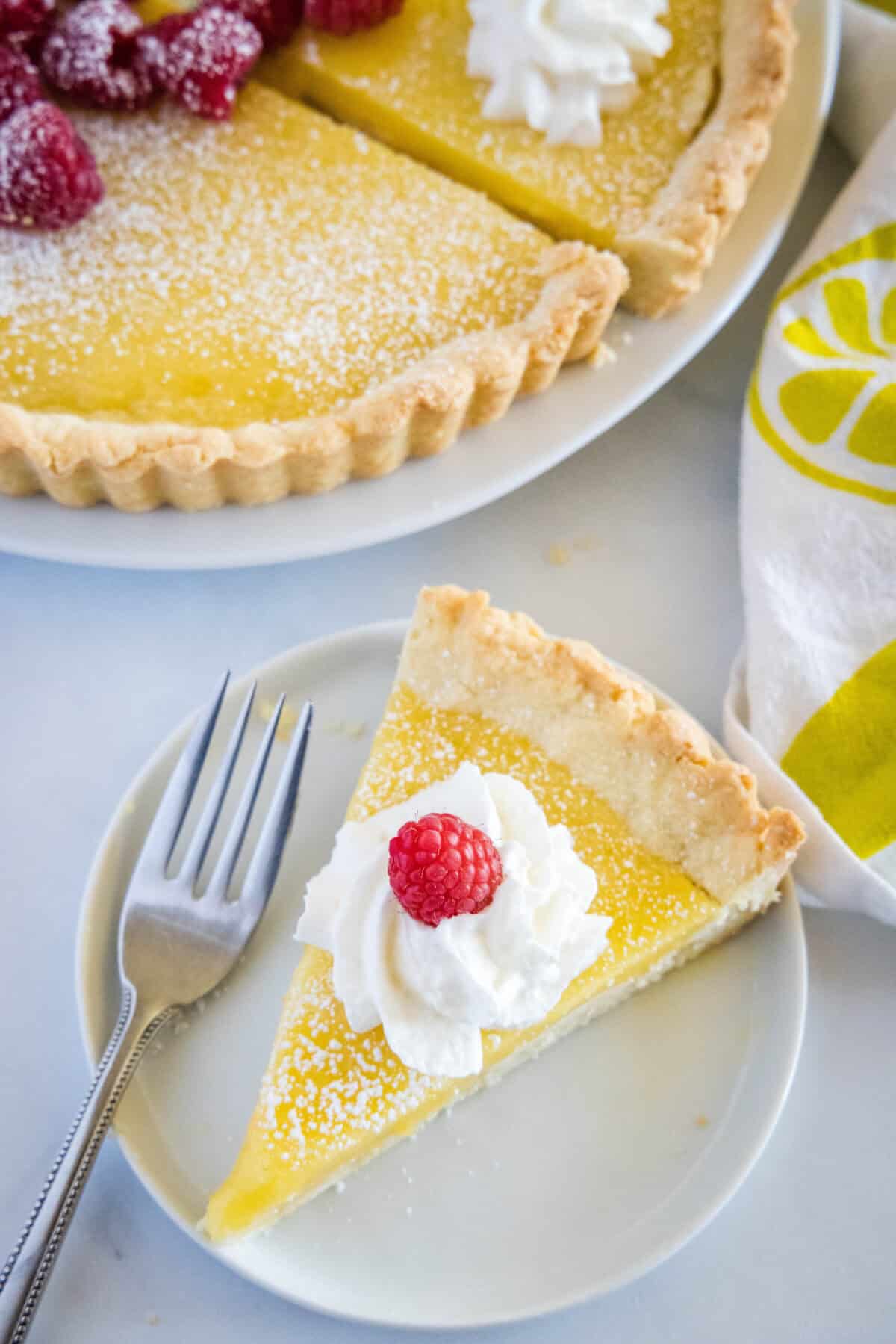 looking down on a slice of lemon tart on a plate